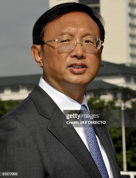 Chinese Foreign Minister Yang Jiechi looks on after taking part in a wreath-laying ceremony during a visit to the monument of Philippine national...