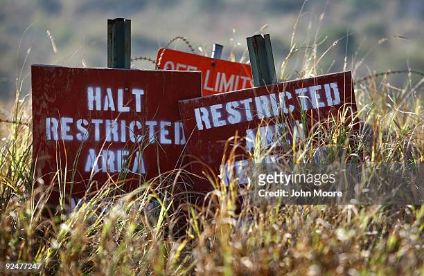 Undergrowth obscures signs near the former Camp X-Ray at the U.S. Military prison for "enemy combatants" on October 28, 2009 in Guantanamo Bay, Cuba....