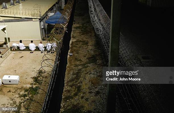 Detainees kneel during an early morning Islamic prayer at the U.S. Military prison for "enemy combatants" on October 28, 2009 in Guantanamo Bay,...