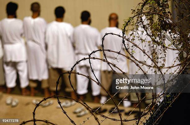 Detainees stand during an early morning Islamic prayer at the U.S. Military prison for "enemy combatants" on October 28, 2009 in Guantanamo Bay,...
