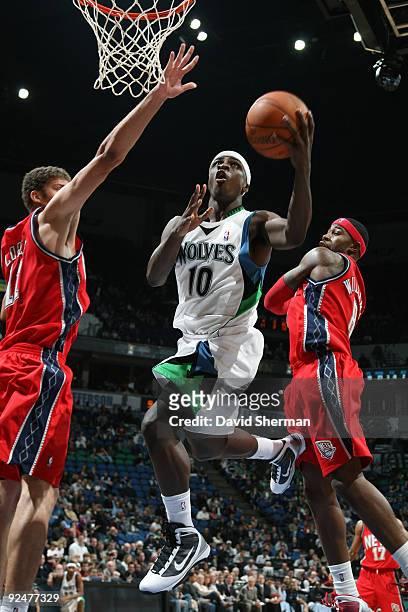 Jonny Flynn of the Minnesota Timberwolves splits the defense against Brook Lopez and Terrence Williams of the New Jersey Nets during the season...
