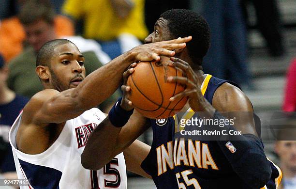 Al Horford of the Atlanta Hawks strips the ball from Roy Hibbert of the Indiana Pacers at Philips Arena on October 28, 2009 in Atlanta, Georgia.