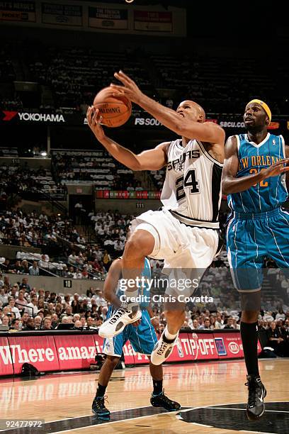 Richard Jefferson of the San Antonio Spurs drives past Julian Wright of the New Orleans Hornets on October 28, 2009 at the AT&T Center in San...