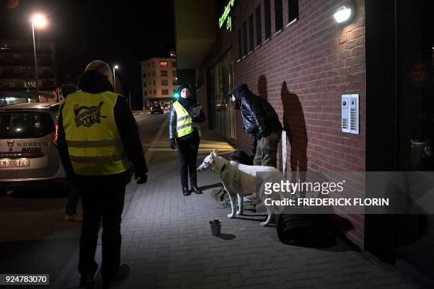 Volunteers of the French charity Les Restos du Coeur give a meal to a homeless man in a street of the eastern French city of Strasbourg, on February...