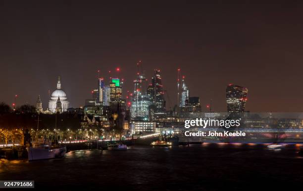 General view of the London skyline at night from Waterloo bridge looking at St Paul's Cathedral, The Heron Tower , National Westminster Tower,...