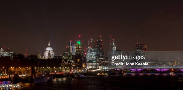 General view of the London skyline at night from Waterloo bridge looking at St Paul's Cathedral, The Heron Tower , National Westminster Tower,...