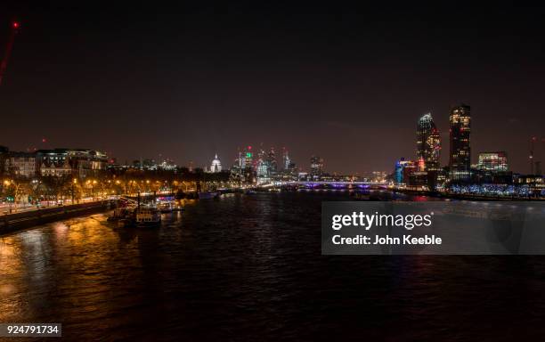 General view of the London skyline at night from Waterloo bridge looking at St Paul's Cathedral, The Heron Tower , National Westminster Tower,...