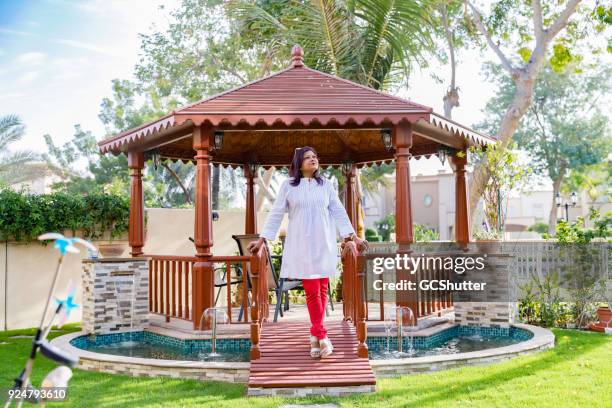 wealthy woman stepping out of her gazebo - belvedere stock pictures, royalty-free photos & images