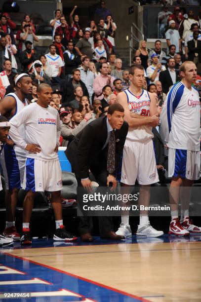 Craig Smith, Sebastian Telfair, Blake Griffin, Steve Novak, and Chris Kaman of the Los Angeles Clippers watch from the bench during their game...