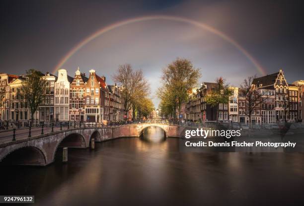 amsterdam sunset view with rainbow - amsterdam canals stockfoto's en -beelden