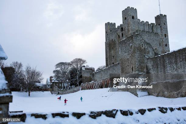 Children play on sledges outside Rochester Castle in the snow on February 27, 2018 in Rochester, United Kingdom. Freezing weather conditions dubbed...