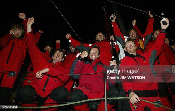 American Adventurer Steve Fossett and his crew of 12 cheer onbuard on the Cheyenne after arriving in Plymouth 05 April 2004, becoming the first...