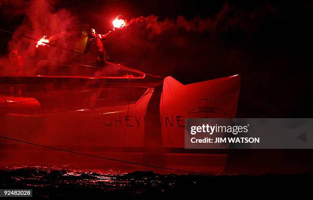 Member of American adventurer Steve Fossett's crew of 12 on the Cheyenne holds up a flare as they make their way around Mount Batten Point in...