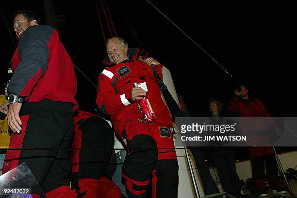 American Adventurer Steve Fossett celebrates with members of his crew of 12 on the Cheyenne in Plymouth 05 April 2004 after becoming the first...