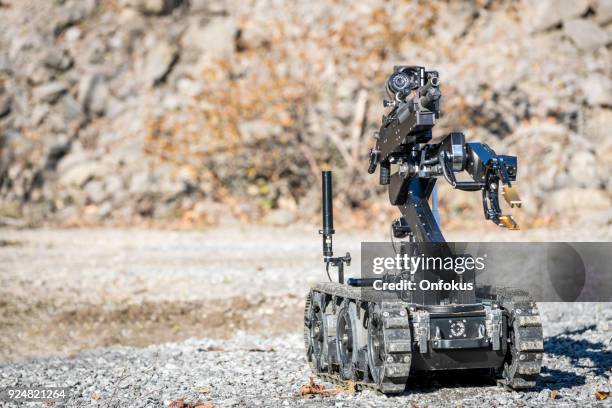 police swat officer using a mechanical arm bomb disposal robot unit - swat team stock pictures, royalty-free photos & images