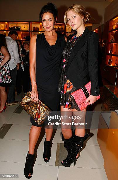 Models Megan Gale and Catherine McNeil pose for a photograph as they arrive for the first anniversary of the Louis Vuitton Collins Street store on...