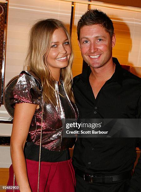 Michael Clarke and Lara Bingle pose for a photograph as they arrive for the first anniversary of the Louis Vuitton Collins Street store on October...