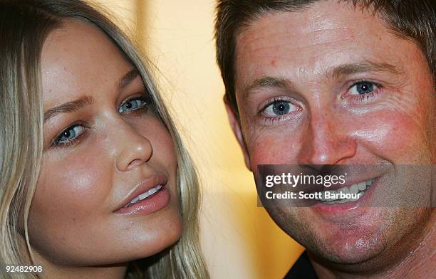 Michael Clarke and Lara Bingle pose for a photograph as they arrive for the first anniversary of the Louis Vuitton Collins Street store on October...