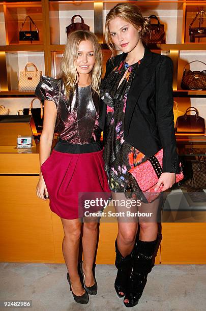 Models Lara Bingle and Catherine McNeil pose for a photograph as they arrive for the first anniversary of the Louis Vuitton Collins Street store on...