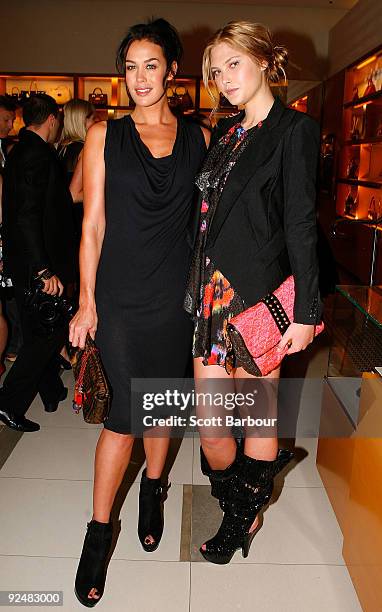 Models Megan Gale and Catherine McNeil pose for a photograph as they arrive for the first anniversary of the Louis Vuitton Collins Street store on...