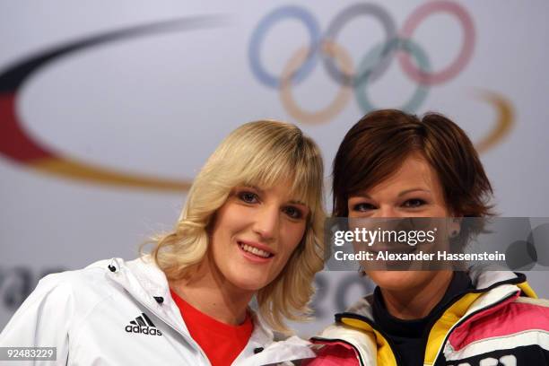 Ski alpine athlete Susanne Riesch poses with her sister Maria Riesch on the catwalk during the presentation of the German athletes Winter Olympic kit...