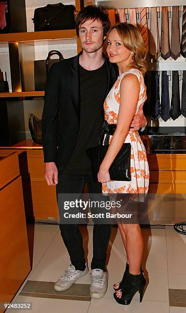 Nicholas Bolton and Jessica Burrow pose for a photograph as they arrive for the first anniversary of the Louis Vuitton Collins Street store on...