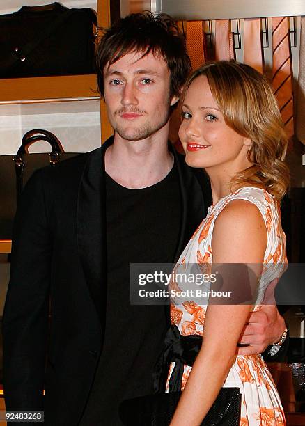 Nicholas Bolton and Jessica Burrow pose for a photograph as they arrive for the first anniversary of the Louis Vuitton Collins Street store on...