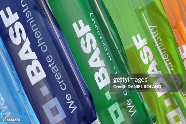 Flags with the logo of German chemical giant BASF flutter in front of the company's headquarters in Ludwigshafen, western Germany, where is being...