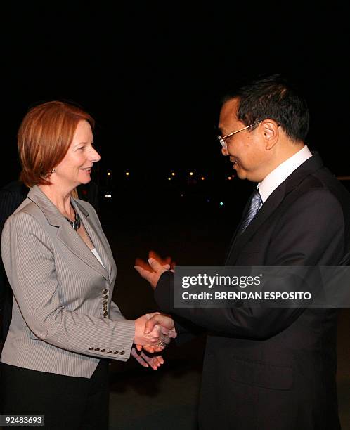 Australian Deputy Prime Minister Julia Gillard shakes hands with Chinese Executive Vice-Premier Li Keqiang as Li arrives in Sydney on October 29,...