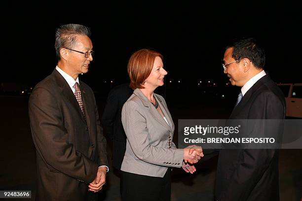 Australian Deputy Prime Minister Julia Gillard shakes hands with Chinese Executive Vice-Premier Li Keqiang as Li arrives in Sydney on October 29,...