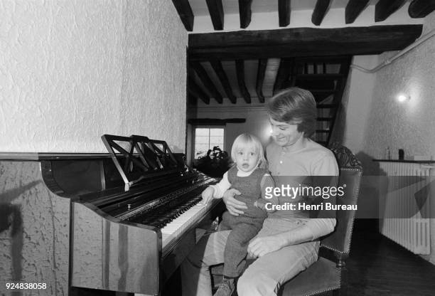 French singer Claude François with his son Claude Francois Junior at home near Fontainebleau , April 1970