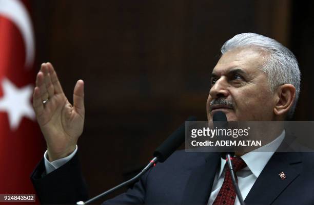 Prime Minister of Turkey and Vice Chairman of Turkey's ruling Justice and Development Party Binali Yildirim raises his hands as he delivers a speech...