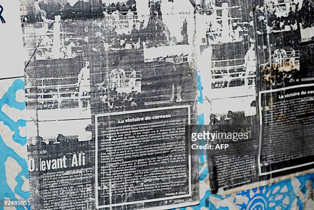 By Emmanuel PEUCHOT- Old newspaper clippings line a wall of a boxing training room on October 29, 2009 where boxing legend Mohamed Ali fought back in...