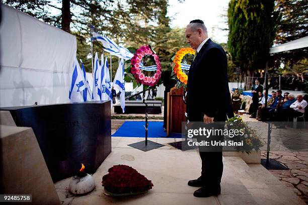 Israeli Prime Minister Benjamin Netanyahu stands by the grave of Israeli Prime Minister Yitzhak Rabin during a memorial ceremony marking the 14th...