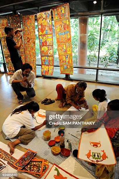 Indian traditional artist Khandu Chitrakar from West Bengal state works on Patta Chitra Katha paintings during a workshop at the National Institute...