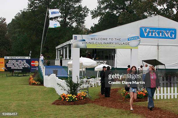 Golf fans walk away from one of the culinary tents after first round play was postponed because of weather in the Viking Classic at the Annandale...
