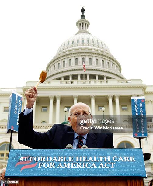 Rep. John Dingell wields the gavel used when he chaired the committee that passed Medicare legislation in 1965 during an event unveiling the House of...