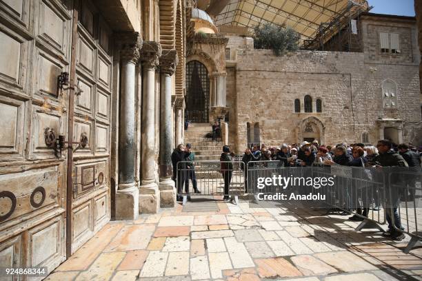 Christians pilgrims wait in front of the closed Church of the Holy Sepulcher after the church is closed to react to tax demands of the Jerusalem...