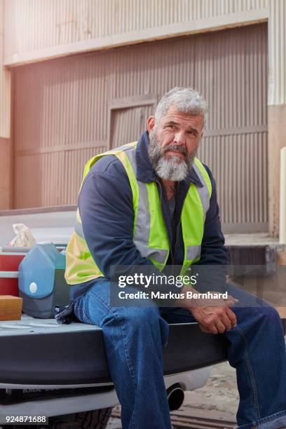 blue-collar worker sits on his pickup truck - builders boots stock pictures, royalty-free photos & images