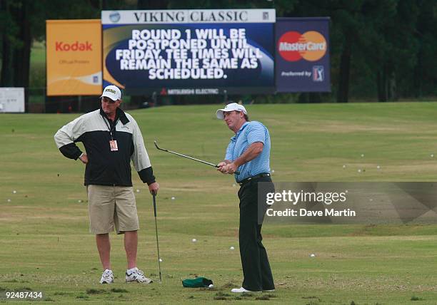 Peter Lonard of Australia chips at the practice range after first round play was postponed because of weather in the Viking Classic at the Annandale...