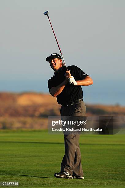 Retief Goosen of South Africa hits his approach shot on the 18th hole during Day One of the Group Stage of the Volvo World Match Play Championship at...