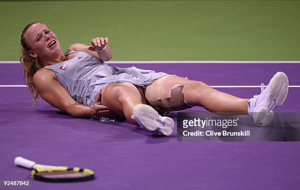 Caroline Wozniacki of Denmark lies on the ground in pain from cramp against Vera Zvonareva of Russia in their round robin match during the Sony...