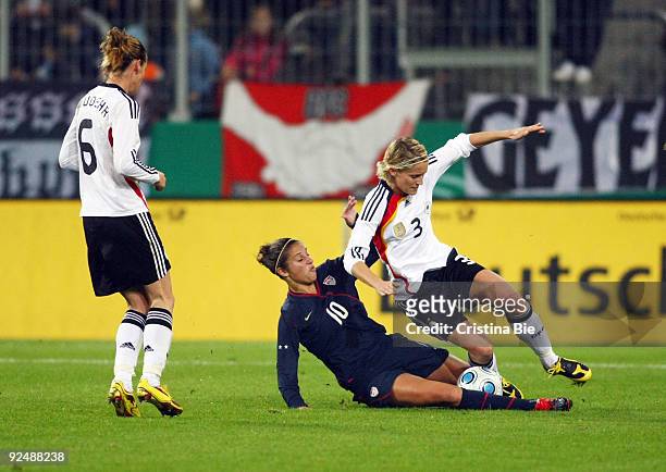 Saskia Bartusiak of Germany and Carli Lloyd of USA tackle for the ball during the Women's International friendly match between Germany and USA at the...