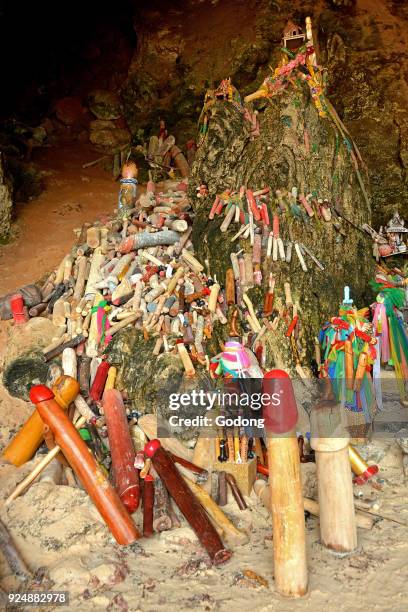 Offerings in a Krabi grotto. Wooden phalluses. Thailand.