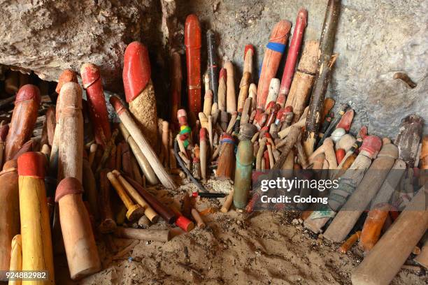 Offerings in a Krabi grotto. Wooden phalluses. Thailand.