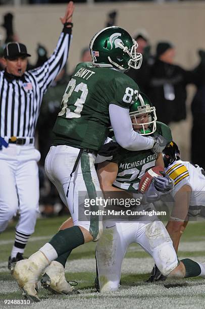 Blair White of the Michigan State Spartans is hugged by Charlie Gantt after catching a touchdown pass in the 4th quarter against the Iowa Hawkeyes at...