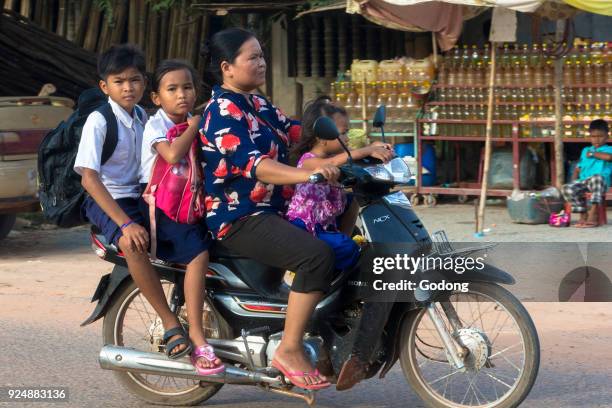 Mother and children riding a scooter in Siem Reap. Cambodia.