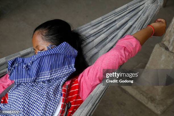 Khmer woman resting in a hammock near Battambang. Cambodia.
