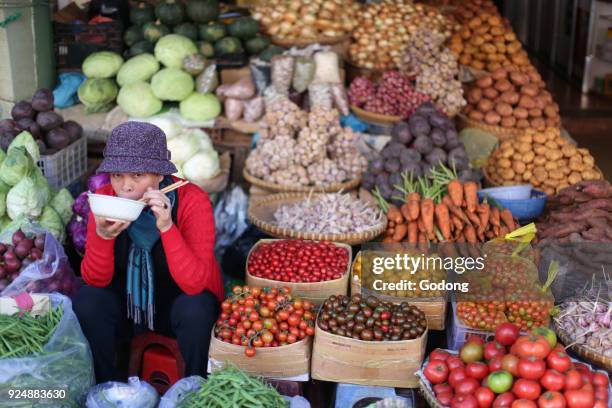 Woman selling fresh vegetables on market. Dalat. Vietnam.