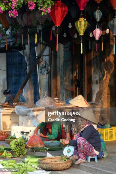 Women in conical hat selling vegetables and fruits. Hoi An. Vietnam.